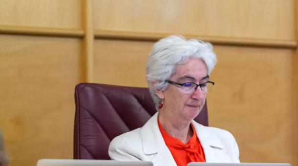 Justice Jennifer Coate sitting at a bench