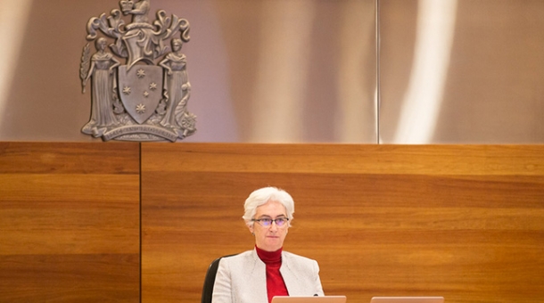 Justice Jennifer Coate sitting at a bench