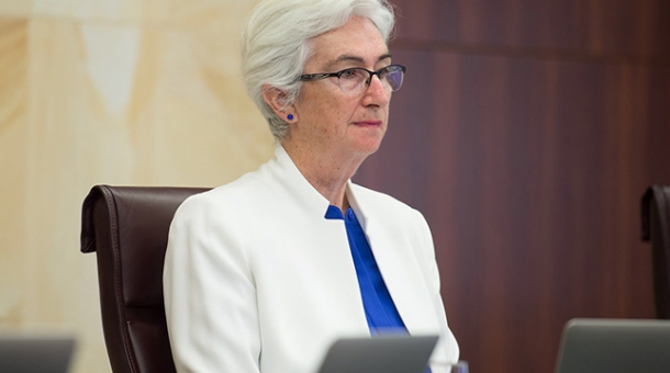 Justice Jennifer Coate sitting at a bench