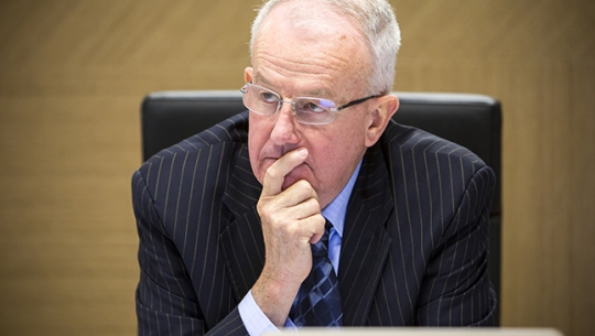 Commissioner Bob Atkinson AO APM sitting at a bench