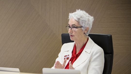 Justice Jennifer Coate sitting at a bench