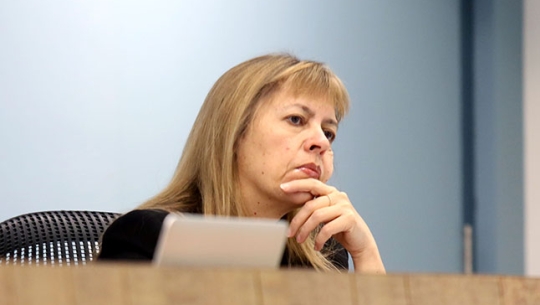 Commissioner Helen Milroy sitting at a bench