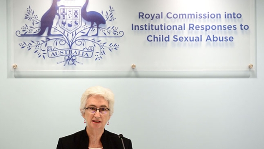 Justice Jennifer Coate sitting at a bench