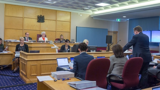 Unidentified legal representatives presenting to Commissioners at the Knox Grammar School public hearing