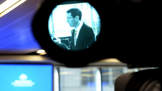 Counsel Assisting, Angus Stewart SC seen through the lens of a video camera during a public hearing