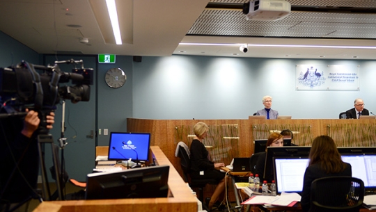 A video camera capturing footage of the public hearing