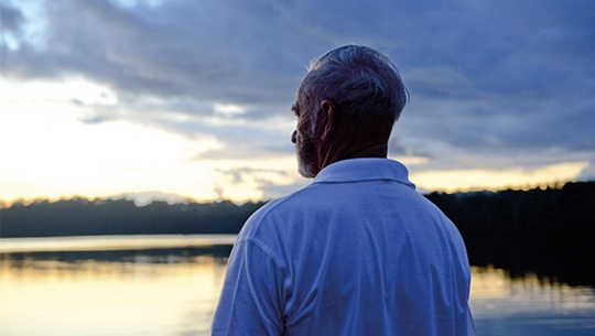 Close up of older man looking out at the sky