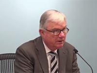 The Hon. Justice Peter McClellan speaking in front of a microphone